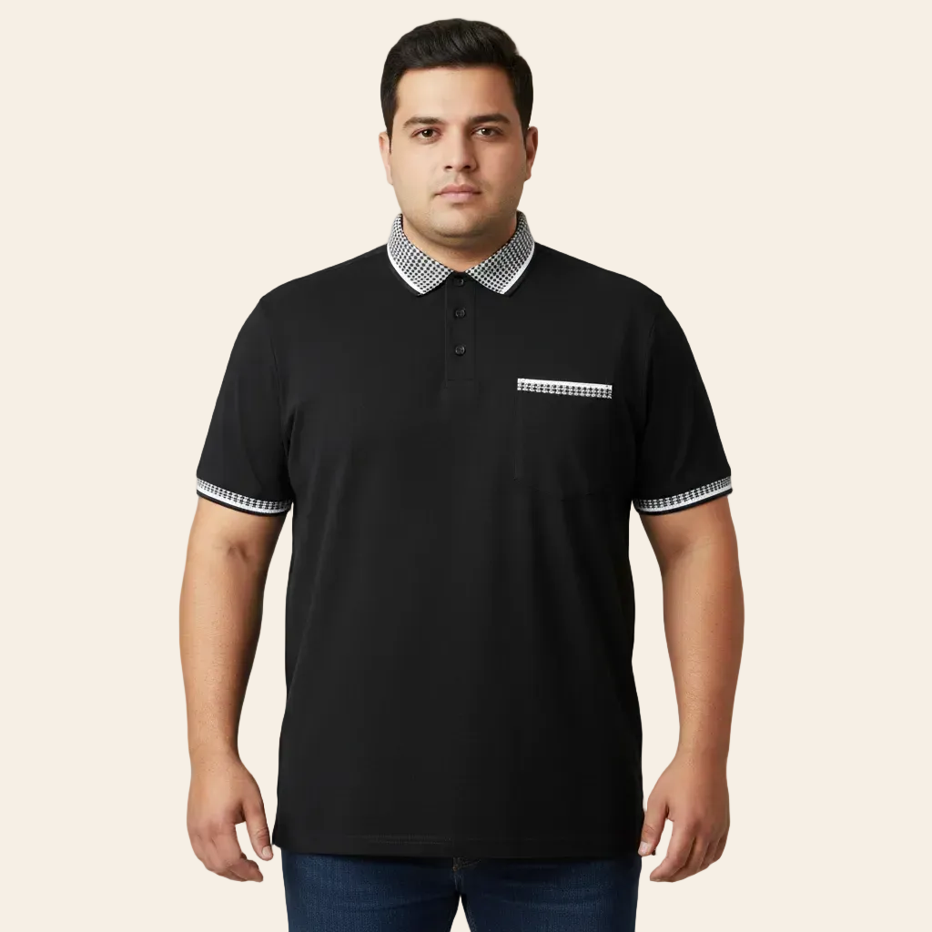 Man wearing a black polo shirt with white trim on a gray background