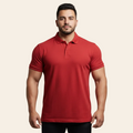 Man wearing a red polo shirt against a gray background
