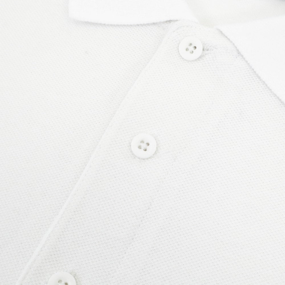 Classic white cotton polo shirt with ribbed collar and three button placket clean minimal design