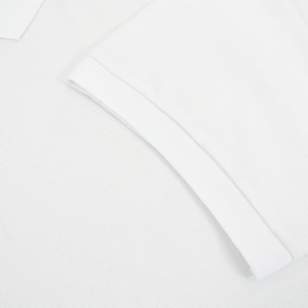 Classic white cotton polo shirt with ribbed collar and three button placket clean minimal design