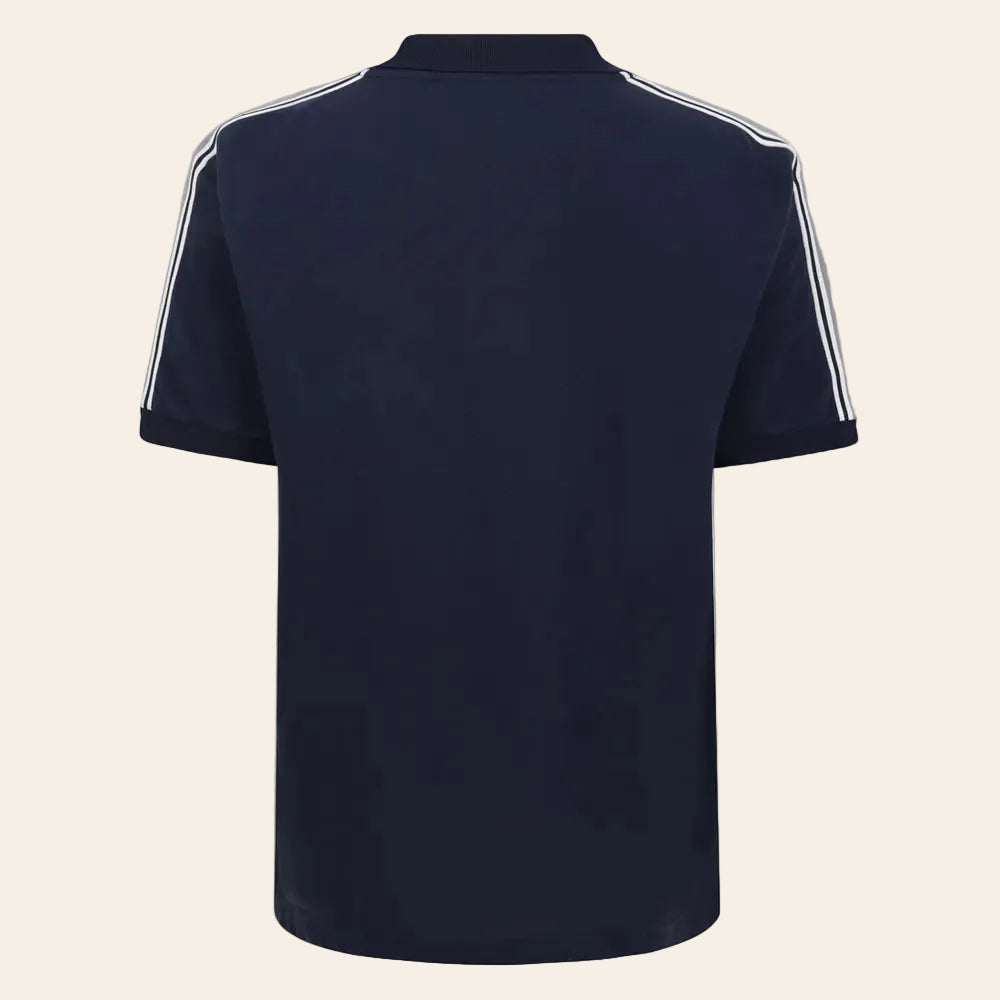 Navy blue shoulder stripe polo shirt with white striped detailing on sleeves, chest pocket, short sleeves, and three button placket on a plain background.