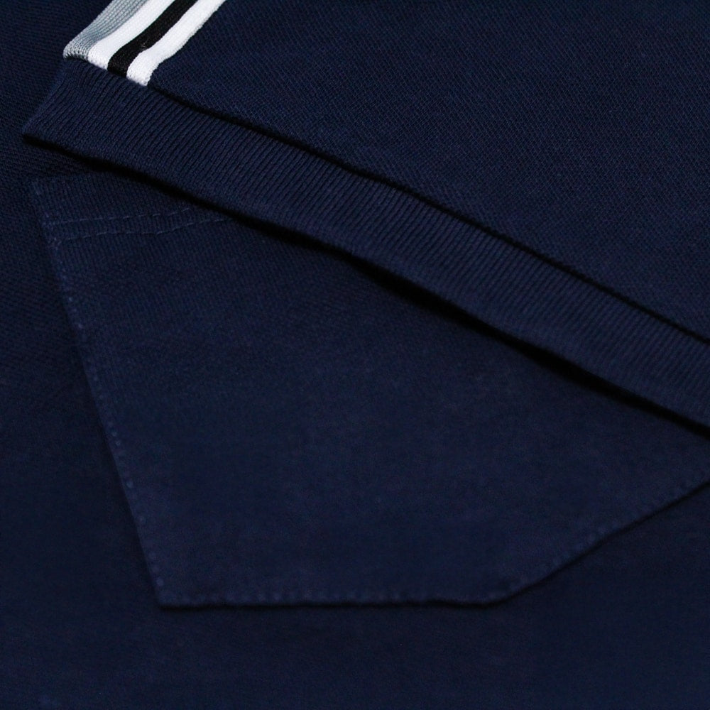 Navy blue shoulder stripe polo shirt with white striped detailing on sleeves, chest pocket, short sleeves, and three button placket on a plain background.