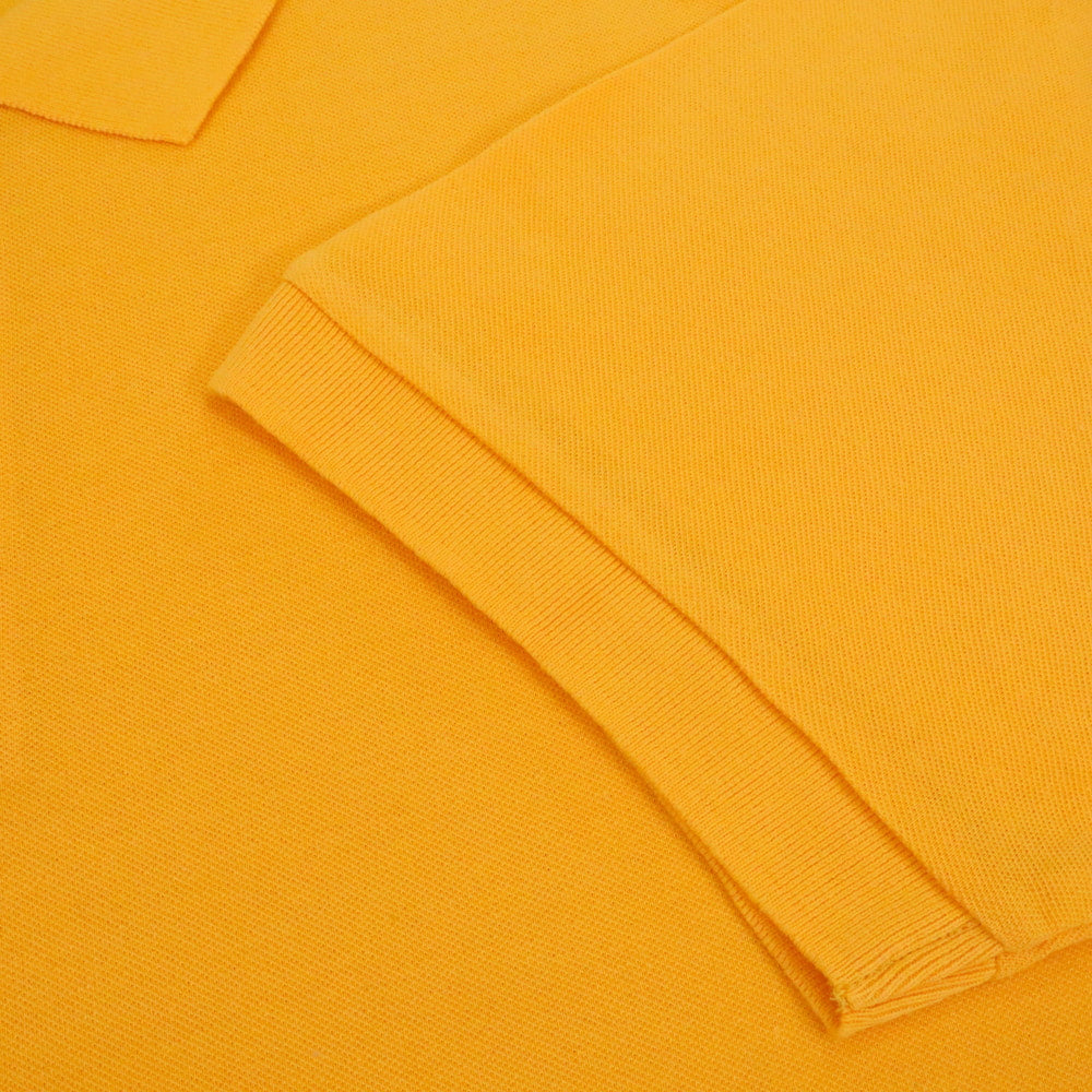 Sunset orange plain polo shirt with ribbed collar and three button placket in cotton blend